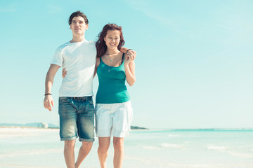 Young Couple Walking on a Caribbean Beach