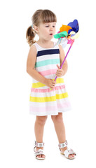 Little cute girl holding toy in her hand, isolated on white