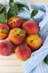 Peaches on napkin on wooden table