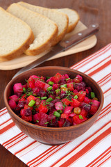 Beet salad in bowl on table close-up