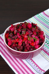 Beet salad in bowl on table close-up