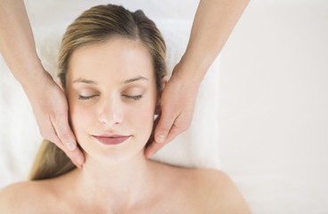 Fototapeta na wymiar Relaxed Woman Receiving Head Massage In Health Spa