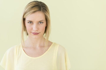 Confident Woman Smiling Against Colored Background