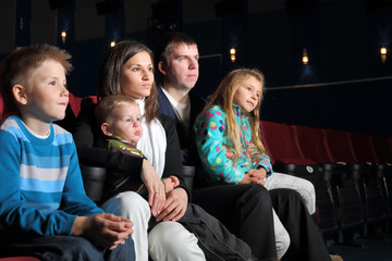 Family watching a movie in the cinema.