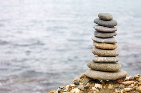 Balanced stack of stones over sea background