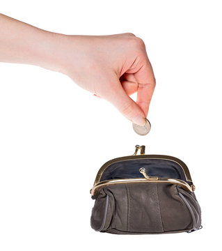 human hand put coin in purse isolated on white