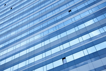 modern facade reflecting blue sky with open windows