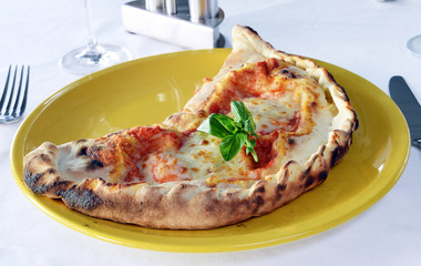 closed calzone pizza with ham