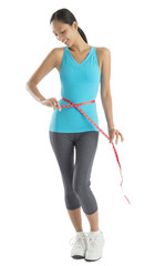 Happy Woman In Sports Clothing Measuring Her Waistline