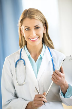 Portrait Of Confident Doctor Holding Clipboard