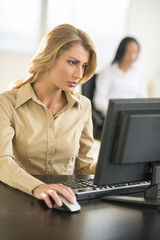 Beautiful Businesswoman Using Computer At Desk In Office