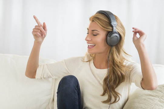 Woman Enjoying Music Through Headphones