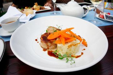 Rabbit meat wrapped in bacon and grilled