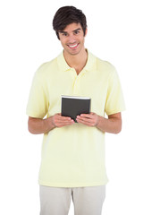 Smiling man holding black notebook