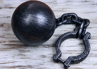 Ball and chain on wooden background