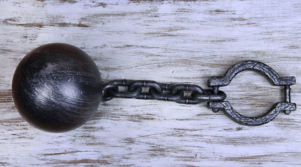 Ball and chain on wooden background