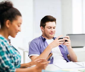 students looking at devices at school