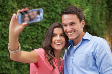 Happy couple making a photo of themselves