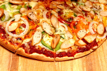 sausage and onion pizza on wood