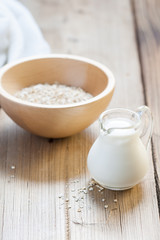 Wooden bowls and a small jug on the wooden background