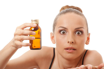 Fototapeta premium woman holding a bottle of medicine, isolated on white background