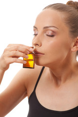 Fototapeta premium woman holding a bottle of medicine, isolated on white background