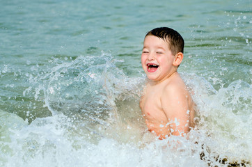 Child playing in surf at beach