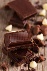 Chocolate pieces and chips on a wooden table