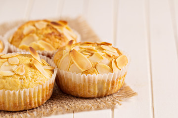 Almond muffins on a wooden table