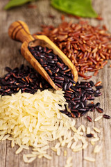 Variety of rice on a wooden background