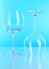 Two glasses on light blue background