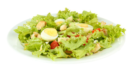 Caesar salad on white plate, isolated on white