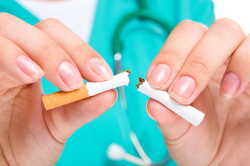 Doctor in uniform breaks cigarette