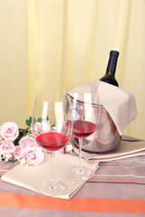 Vine and glasses on round table on cloth background