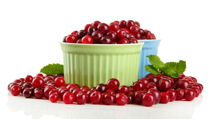 Ripe red cranberries in bowls, isolated on white.