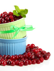 Ripe red cranberries in bowls, isolated on white.