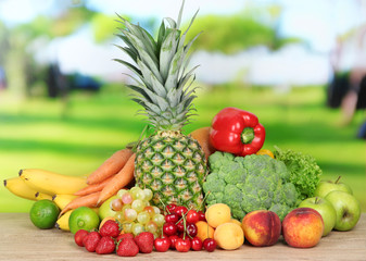 Assortment of fresh fruits and vegetables on natural background