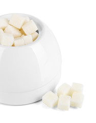 Refined sugar in white sugar bowl on grey background