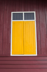 Naklejka na ściany i meble Yellow window on Wooden background