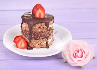 Chocolate cake with strawberry on wooden table close-up