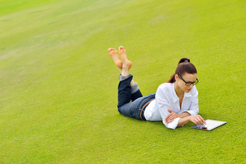 Beautiful young woman with  tablet in park © .shock