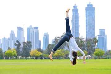 Fototapeta na wymiar young woman jumping in park