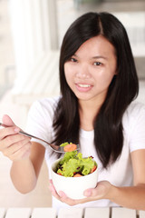 lady holding bowl with fresh salad