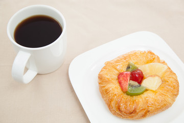 Coffee cup and croissant