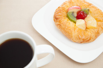 Coffee cup and croissant