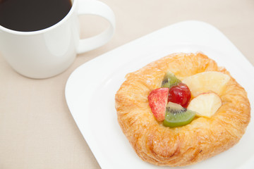 Coffee cup and croissant