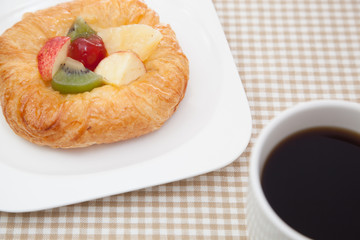 Coffee cup and croissant