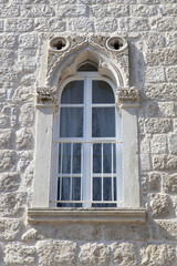White renovated window in a natural stone Mediterranean house