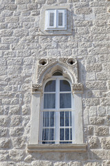 Fototapeta na wymiar White renovated window in a natural stone Mediterranean house