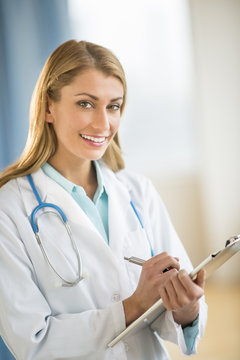 Happy Female Doctor Holding Clipboard